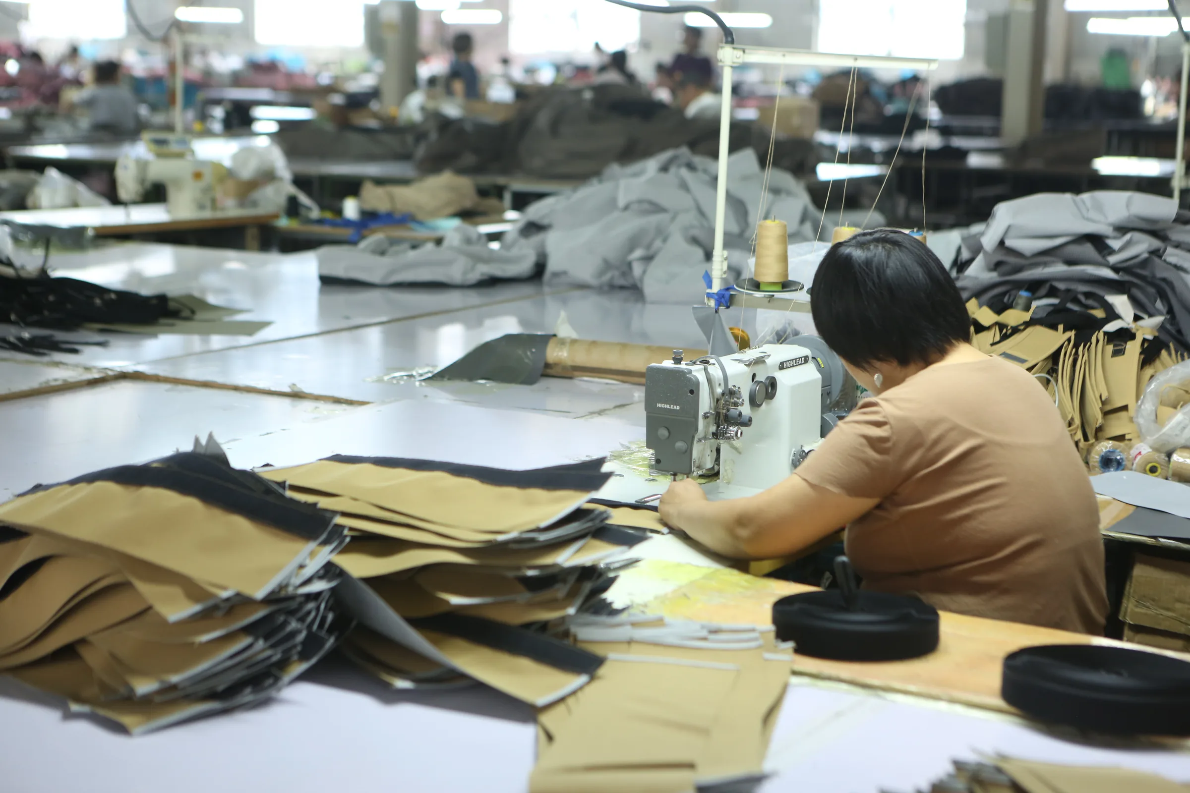 Sewing tan tent components on the production line